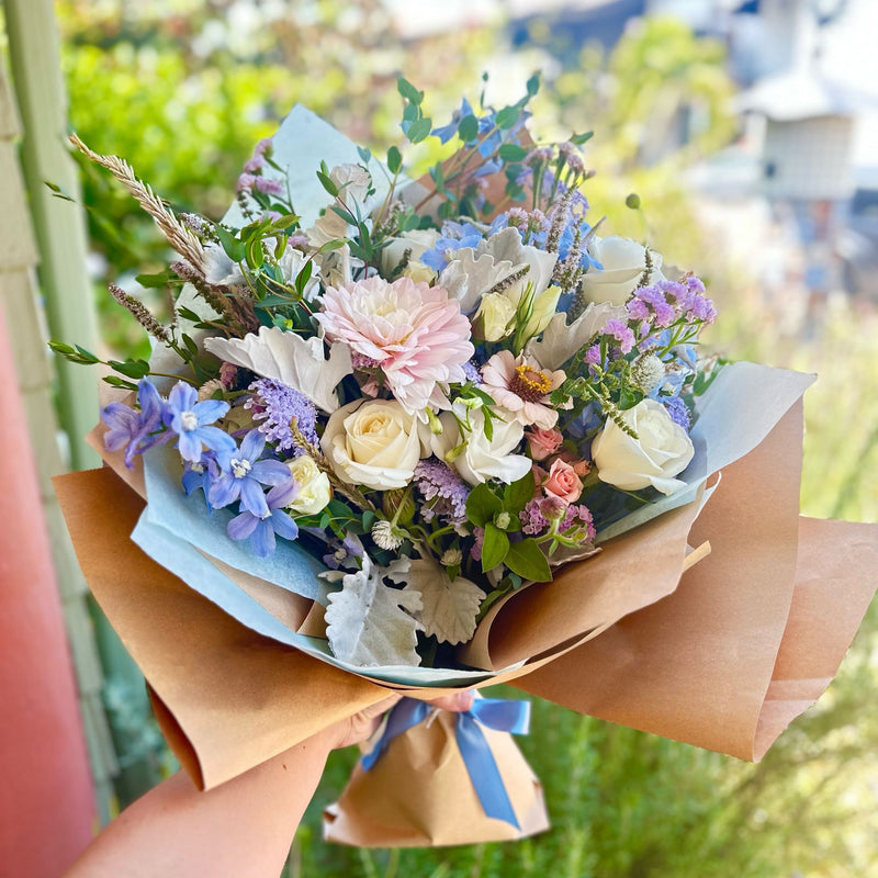 Soft and Dreamy Lush Bouquet featuring delphinium, statice, zinnias, dahlias, roses and more. 