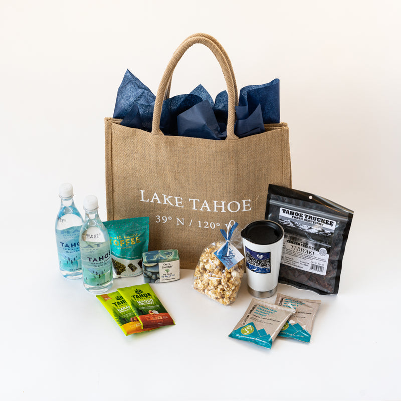 Example of a curated Lake Tahoe Welcome Bag with water, snacks, jerky, soap and more. 