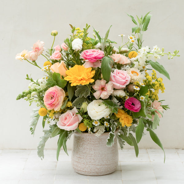 large santa barbara floral arrangement featuring white, yellow and pink flowers